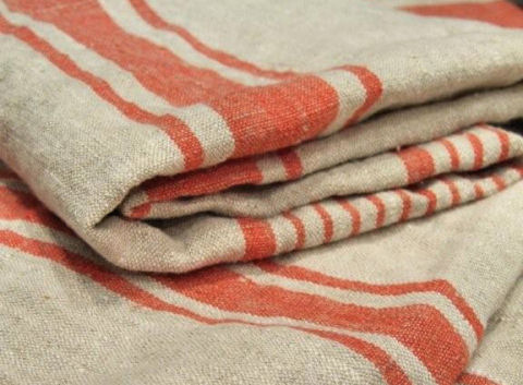 Serviettes huckaback en lin naturel et rayées rouille pliées