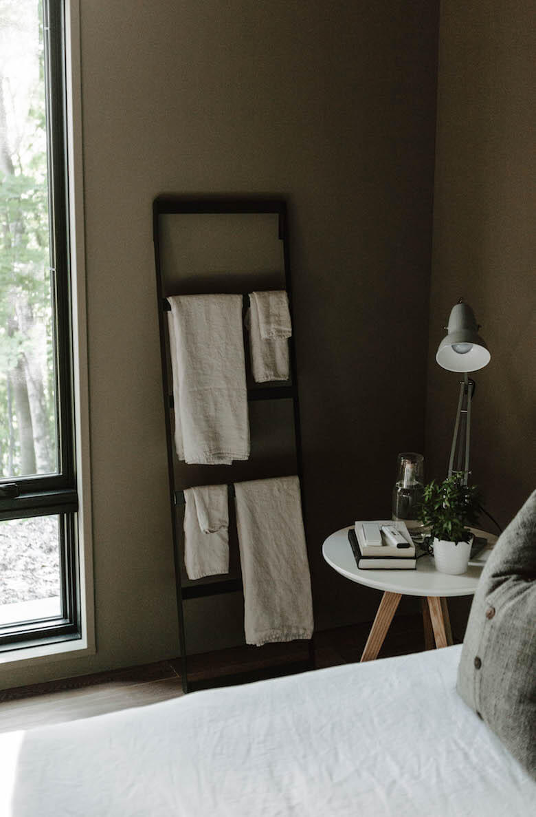 Serviettes et textiles en lin pliés sur une échelle en bois dans la chambre de Birch Le